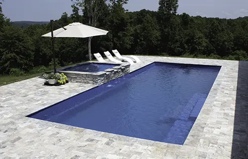 Leisure Pools The Grand rectangular fiberglass composite pool for lounging, installed by Leisure Pools Boston North